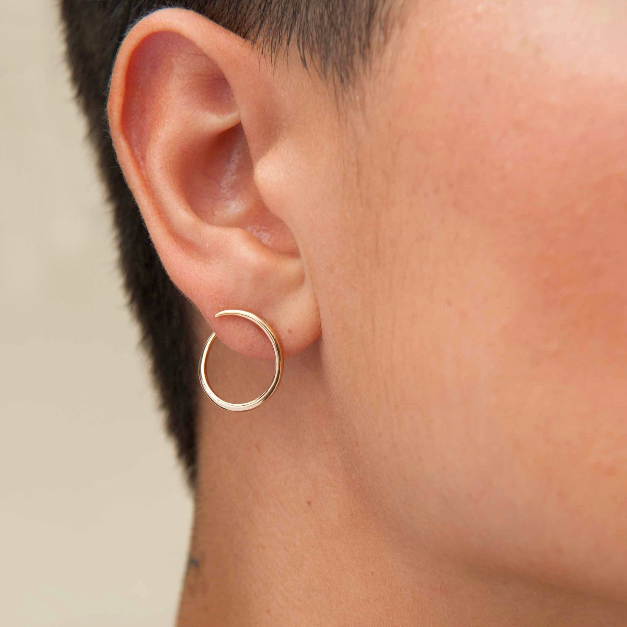 Solid 14k gold modern hoop earrings that wrap around earlobe. 